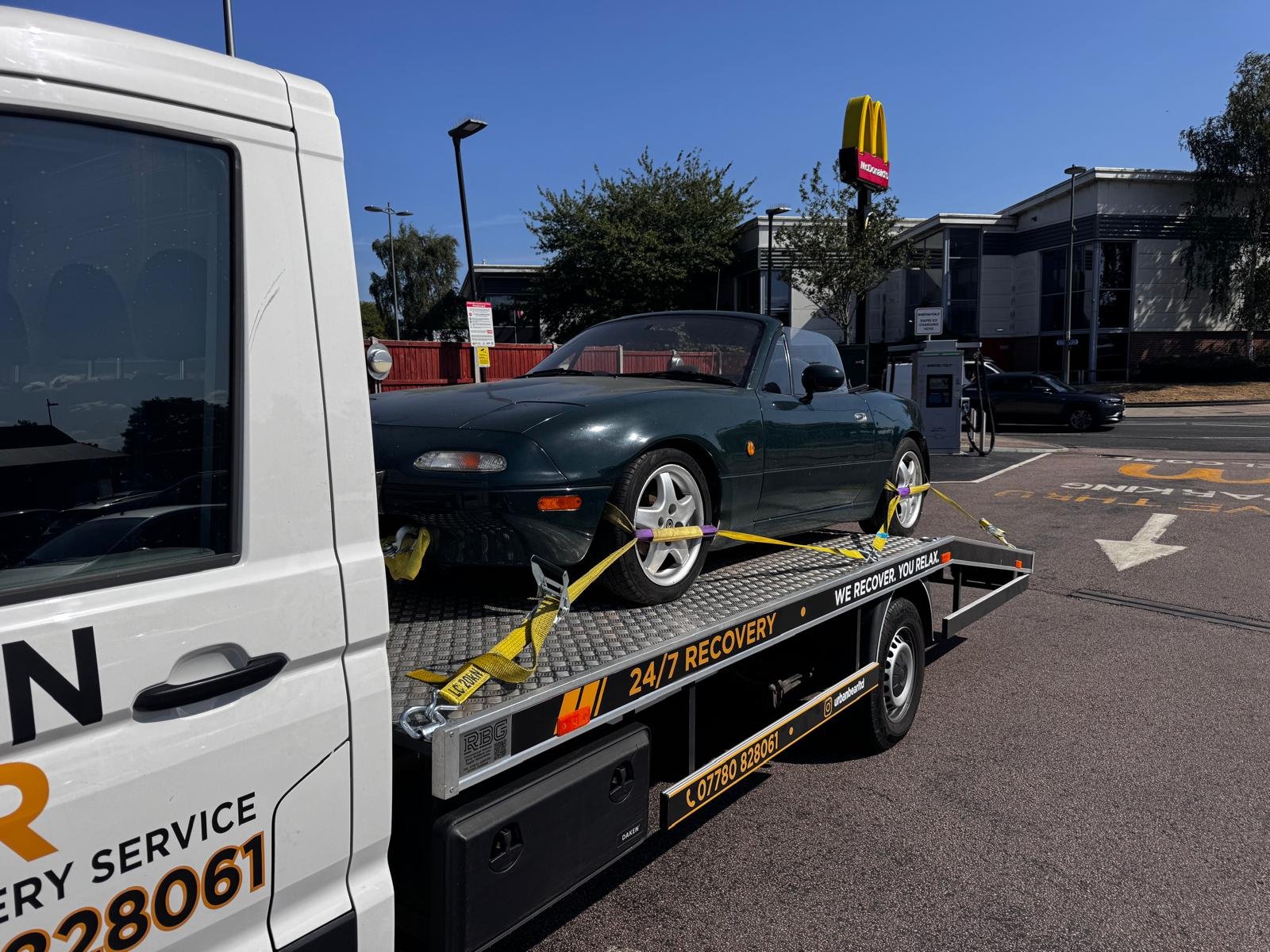 Low sports car loaded — extra care on the approach angle