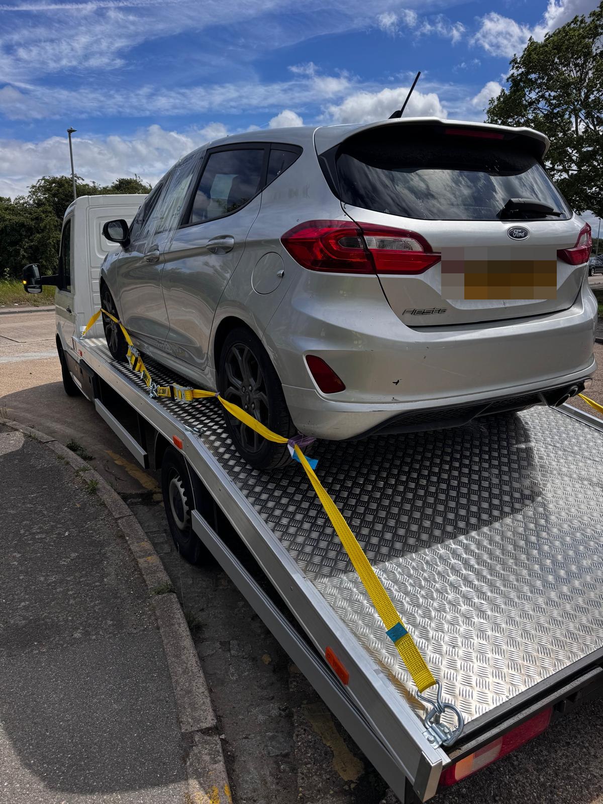 Hot hatch on the bed, straps over the wheels not the bodywork